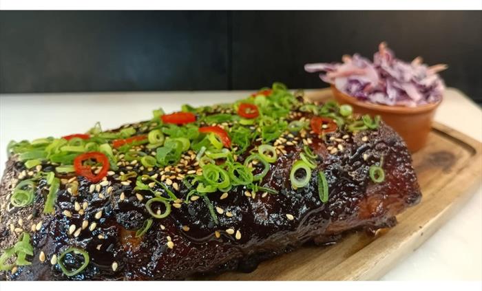 marinated and served with pickled chillies, spring onions, sesame seeds and coleslaw